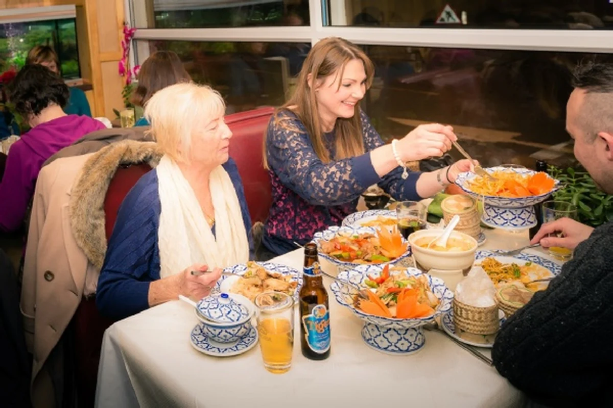 Guests enjoying Thai dishes together at Thai Palace