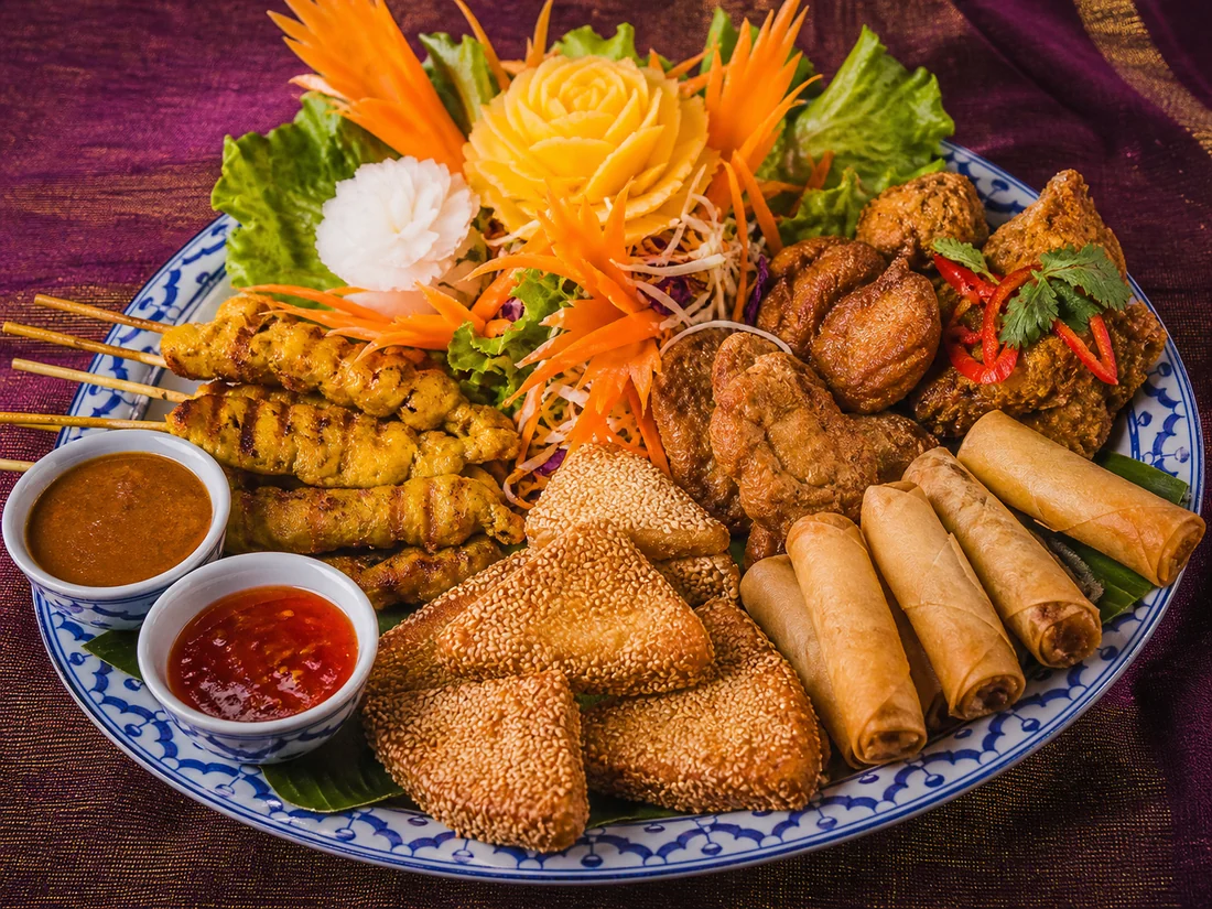 Thai mixed starter with satay, spring rolls and sesame prawn toast